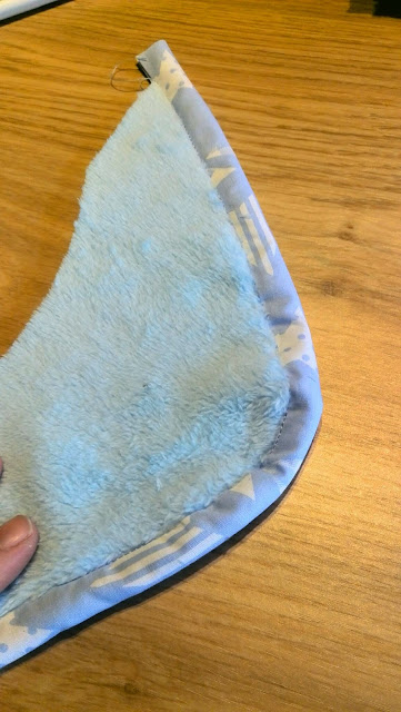 Mouw van babyslaapzakje afgewerkt met biaislint in bijpassende sterren-stof