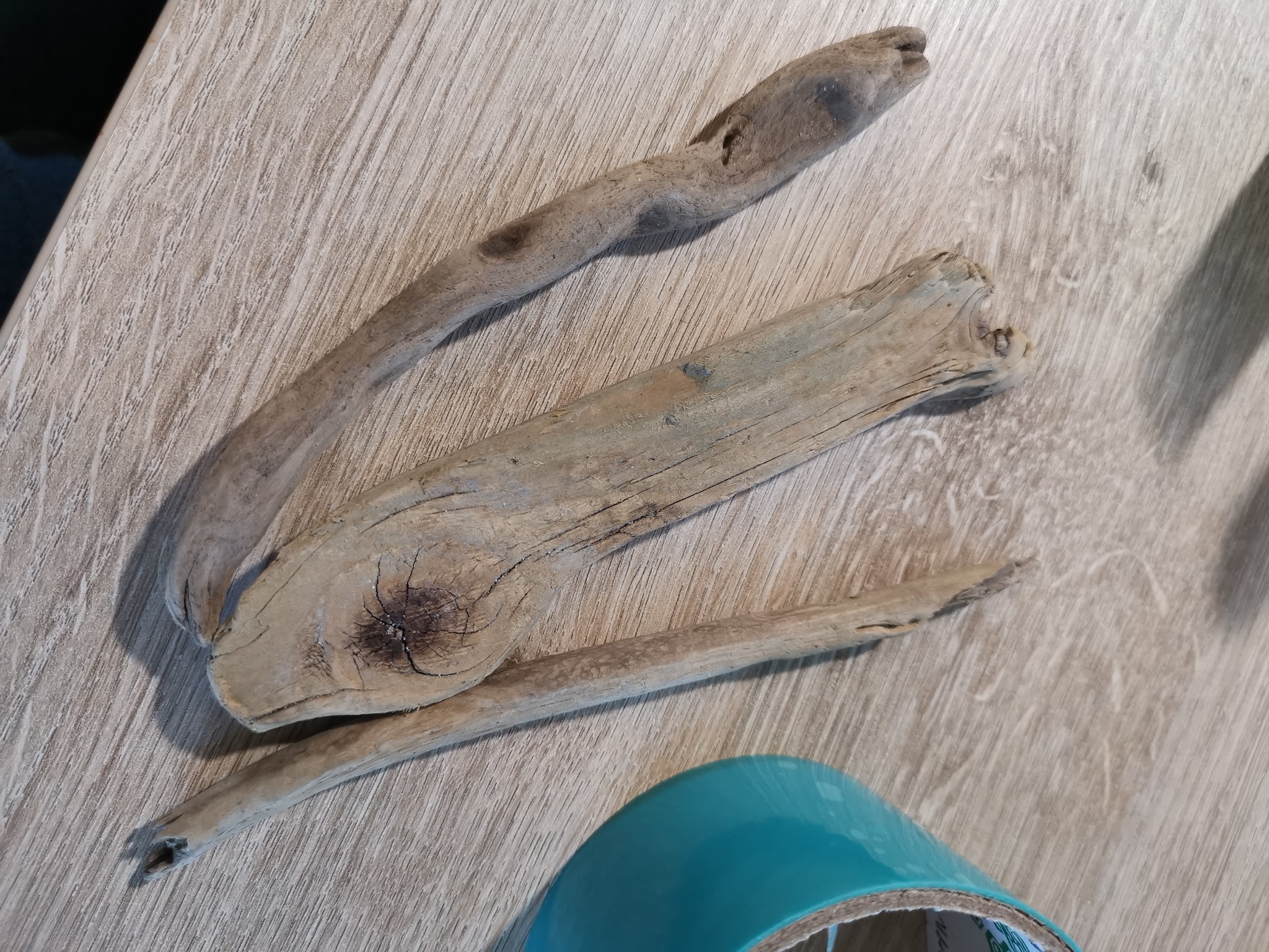 Geselecteerde drijfhoutstukken uitgelegd op tafel — lang genoeg, stevig en niet te dik