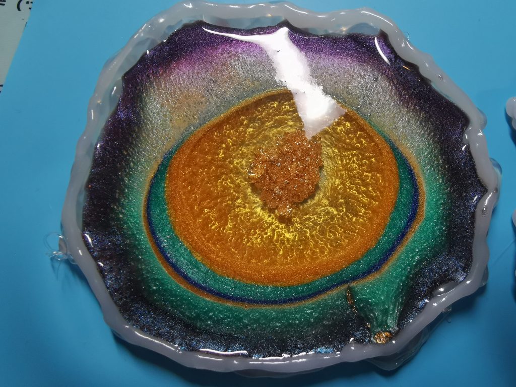Resin geode onderzetter close-up met warme kleurkern