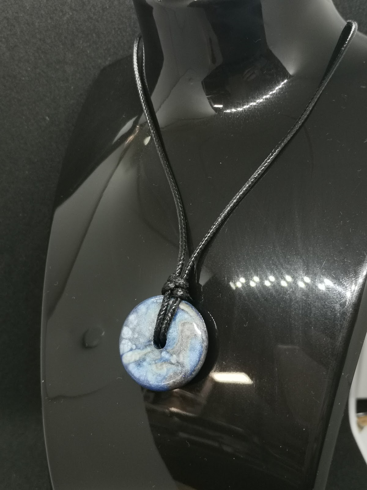 Necklace on bust: adjustable black cord threaded directly through the hole of the blue marble donut bead