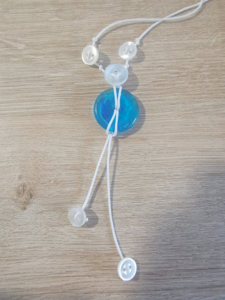 De knoopjes worden bevestigd en vastgezet aan de uiteinden van de hangers